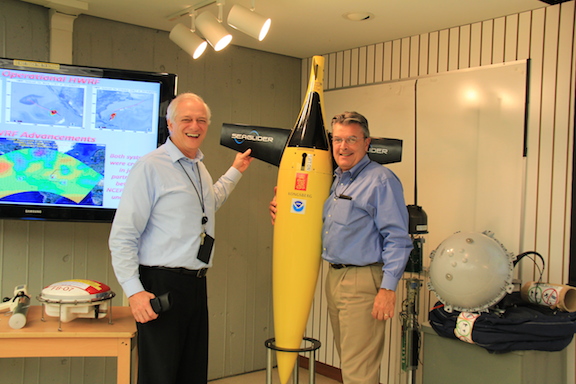 Dr. Gustavo Goni stops NOAA Deputy Assistant Administrator Craig McLean from taking the underwater glider display home with him. Image credit: NOAA