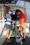 AOML interns prepare a bucket to be used to collect water samples on Ocean Sampling Day 2014. Image credit: NOAA