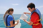 Two AOML interns work to collect a sample off the Florida Keys on Ocean Sampling Day 2014. Image credit: NOAA