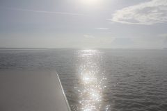 Stunning silver sea meets a noon sky aboard small boat in the Florida Keys. Photo Credit: NOAA.