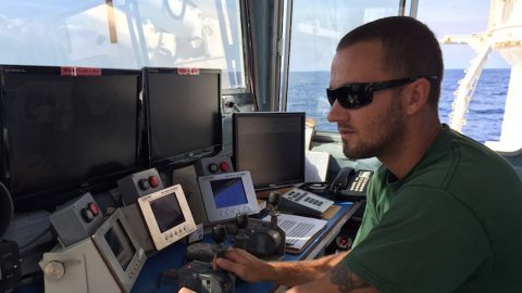 Ethan Irons is one of the three crew running the winch to owed the CTD, The crew runs 24 hour watches: 4 hours on and 8 hours off. Image credit: NOAA.