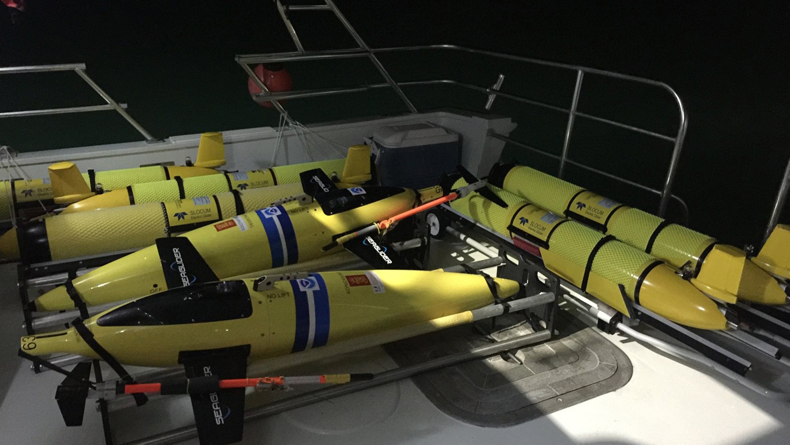 Numerous underwater gliders on the deck of a ship for the hurricane glider project.