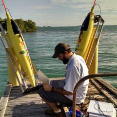 Grant Rawson tests the technological equipment before deploying the two underwater gliders. Image credit: NOAA