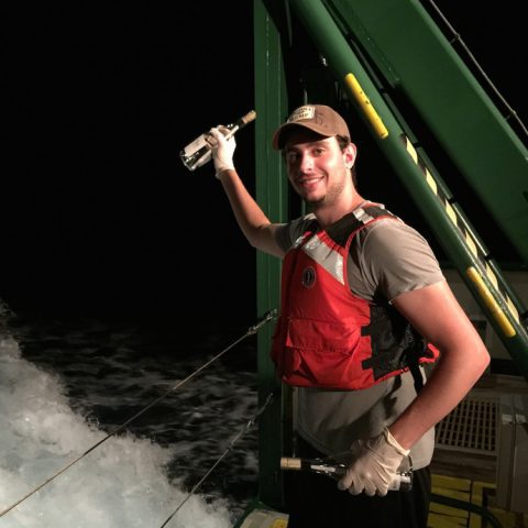 AOML Intern Ciro Liutti gets ready to release a message in a bottle off the back of the F.G. Walton Smith into the Florida Current. Image credit: NOAA