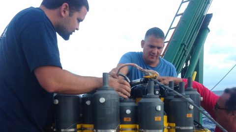 AOML scientists Erik Valdes, Pedro Pena, and Robert Roddy check on the CTD equipment prior to deployment. Image credit: NOAA