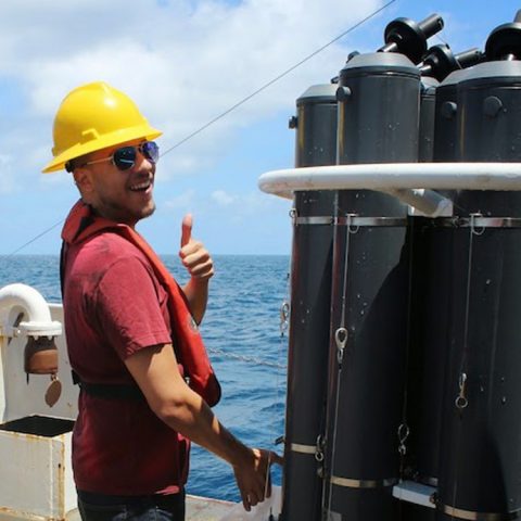 Josué Millán from the University of Puerto Rico collects a water sample from a CTD bottle. Image credit: NOAA