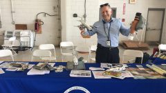 AOML Scientist Stan Goldenberg poses with instruments and models for teaching visitors about hurricane data collection. Image credit: NOAA