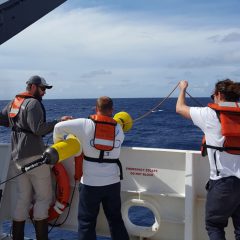 From left to right, Ian, Andy, and Christian deploying an ARGO float. Photo Credit: NOAA.