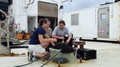 Setting up oxygen change experiments in a mini “ocean” on deck. Photo Credit: NOAA.