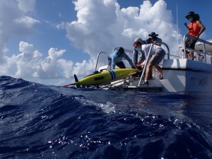 A yellow underwater glider is deployed into the waters of the Bahamas in August of 2021.
