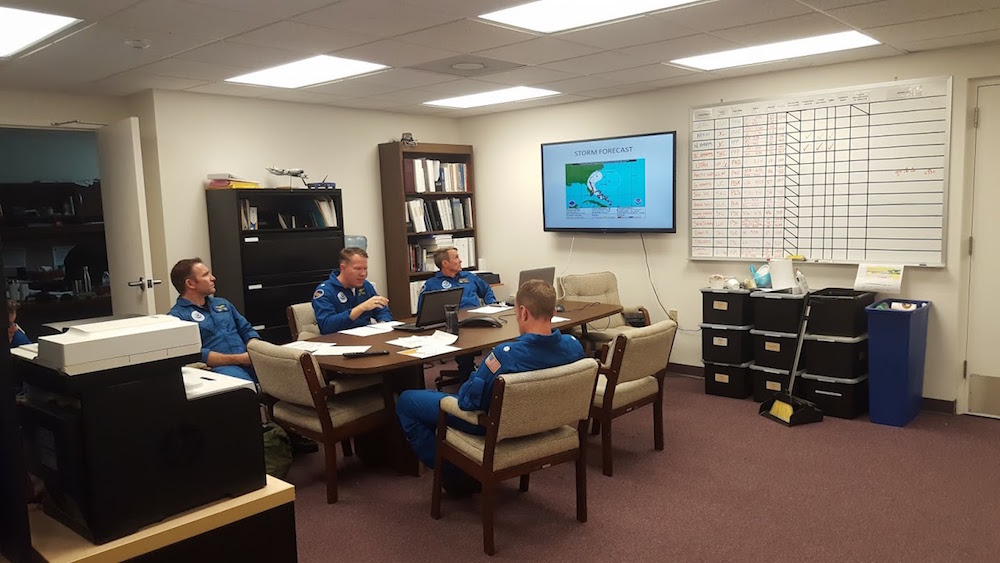 NOAA Hurricane Hunters going over the mission. Image credit: NOAA