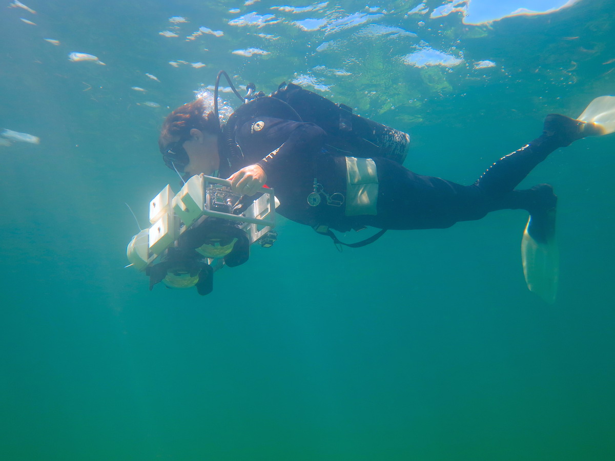 A University of Miami coral scientist collects photos of a reef to be compiled into a photo mosaic. Image credit: NOAA