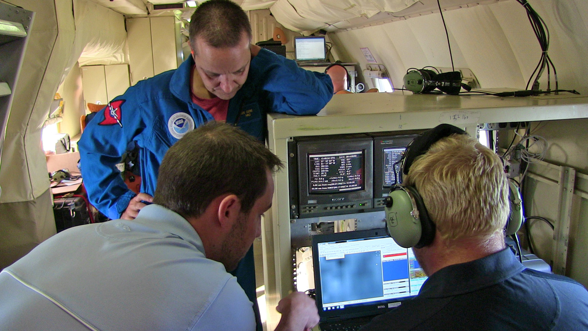 The crew monitors the in-flight Coyote UAS from the piloting station on the P3.