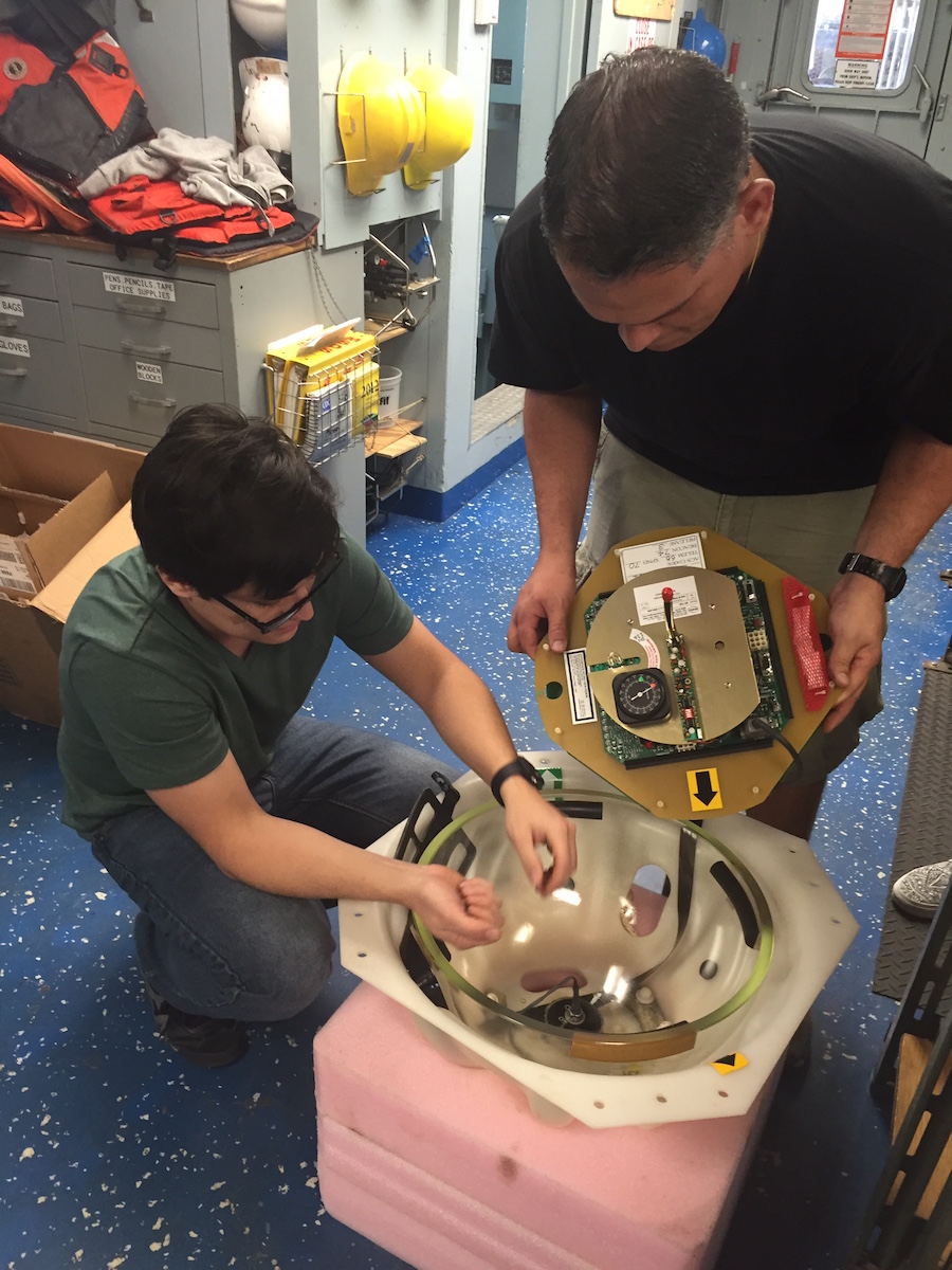 A pressure inverted echo sounder is taken apart and inspected aboard the R/V Endeavor. Image credit: NOAA