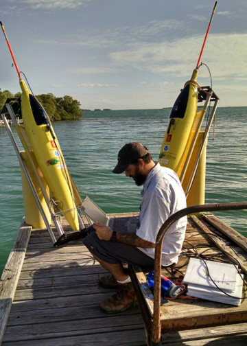 Grant Rawson tests the technological equipment before deploying the two underwater gliders. Image credit: NOAA