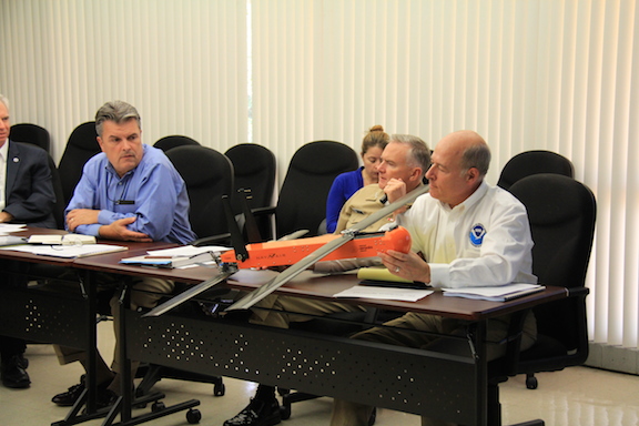 NOAA Leadership examines the Coyote Unmanned Aerial System during a discussion about hurricane research. Image credit: NOAA 