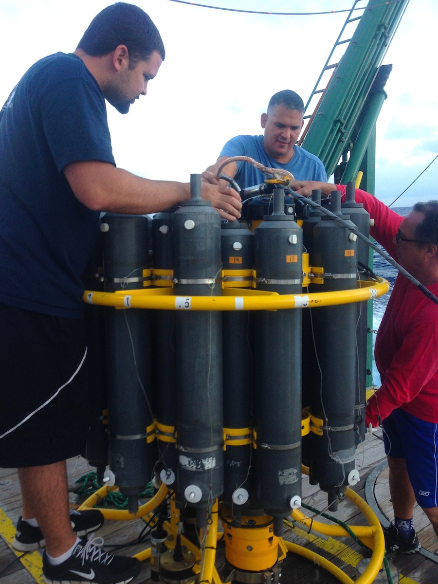 AOML scientists Erik Valdes, Pedro Pena, and Robert Roddy check on the CTD equipment prior to deployment. Image credit: NOAA