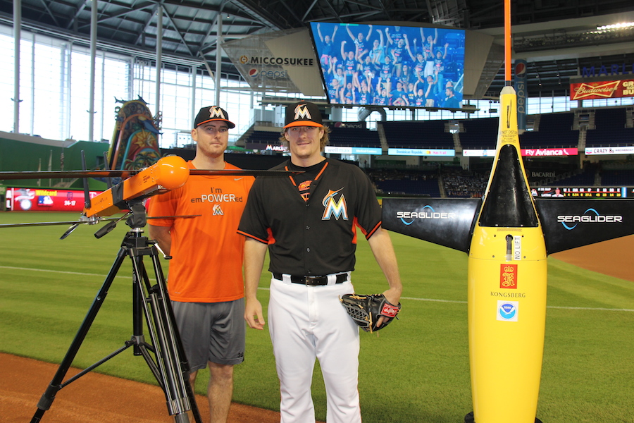 Marlins players take a photo with the Coyote UAS and the ocean glider. Image credit: NOAA