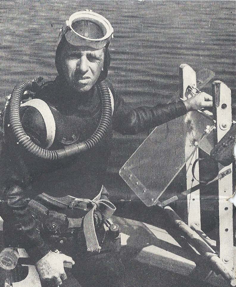 Outfitted for dive, Dr. Harris B. Stewart wears full skin-diving regalia, holds geologist tools, underwater sled. Photo Credit: NOAAA.