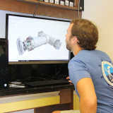 Scientist Nathan Formel Engineers underwater sampling device parts using CAD software in the Advanced Manufacturing Lab Photo Credit: NOAA