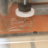 A close-up shot of a machine creating circuitry for scientific instruments in AOML's Advanced Manufacturing Lab