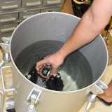 Testing an underwater sampler in a high-pressure underwater tank after its assembly in AOML's Advanced Manufacturing Lab. Photo Credit: NOAA.