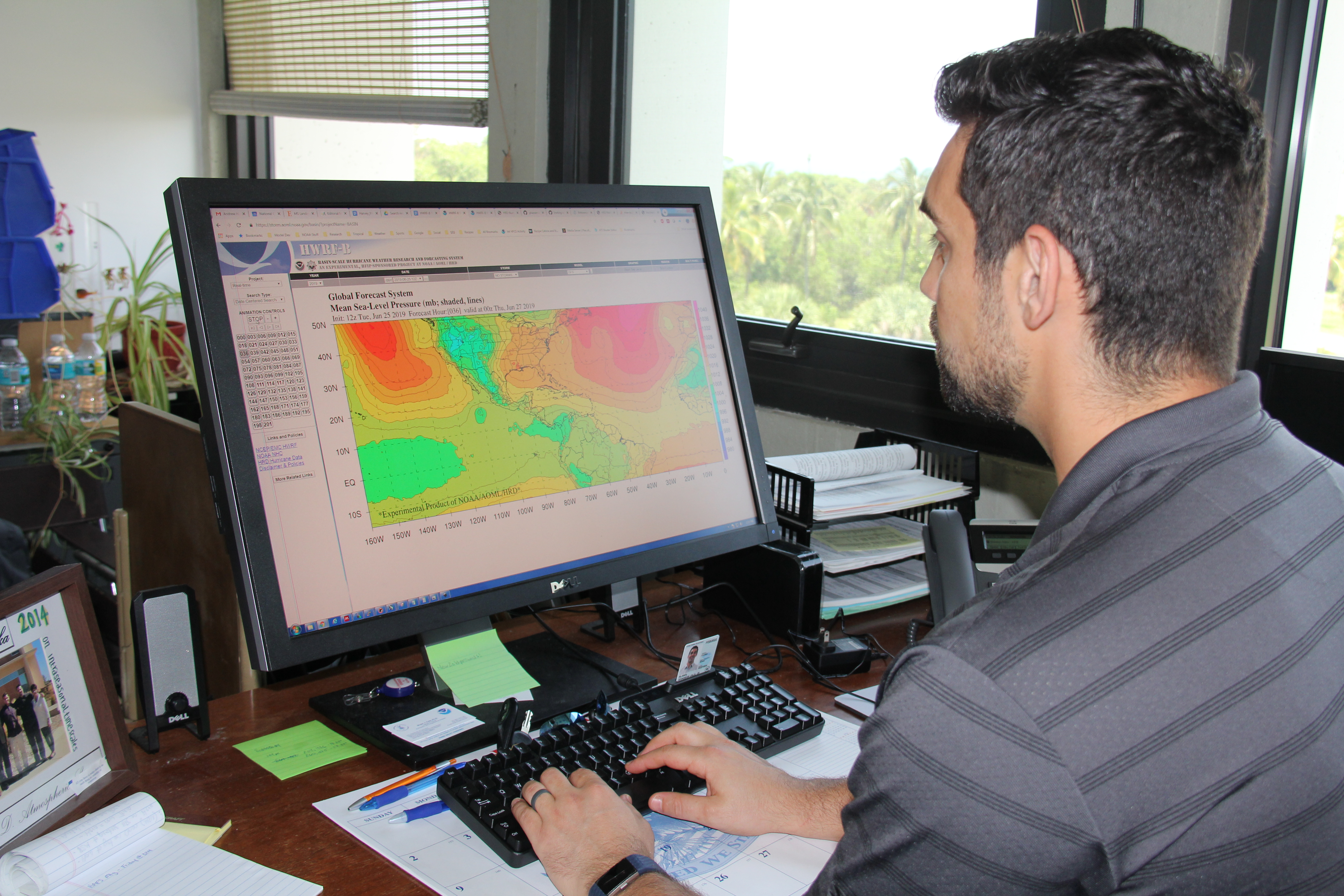 Ghassan "Gus" Alaka evaluating HWRF-B forecasts. Photo Credit: NOAA AOML.