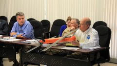 NOAA Leadership examines the Coyote Unmanned Aerial System during a discussion about hurricane research. Image credit: NOAA