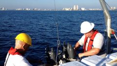 Jack Stamates and Charles Featherstone preparing the CTD (conductivity-temperature-density) instrument for the next cast into the coastal ocean near Miami-Dade. Image credit: NOAA