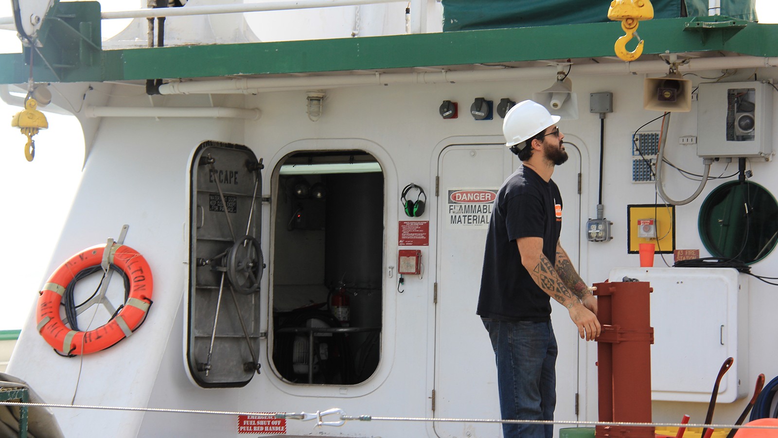 Grant Rawson stabilizes the equipment as it is loaded onto the R/V F.G. Walton Smith. Image Credit: NOAA