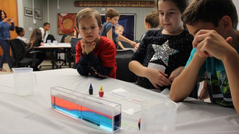 Students participate in a water density demonstration. Image credit: NOAA