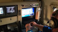 Scientist at the dropsonde station of the flying lab during tropical storm Hermine. Photo Credit: NOAA AOML.