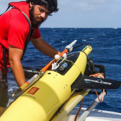 Scientists and crew get ready to send the underwater glider into the ocean. Image credit: NOAA