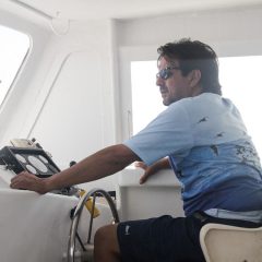 Scientist looks on as he traverses the waters. Image credit: NOAA