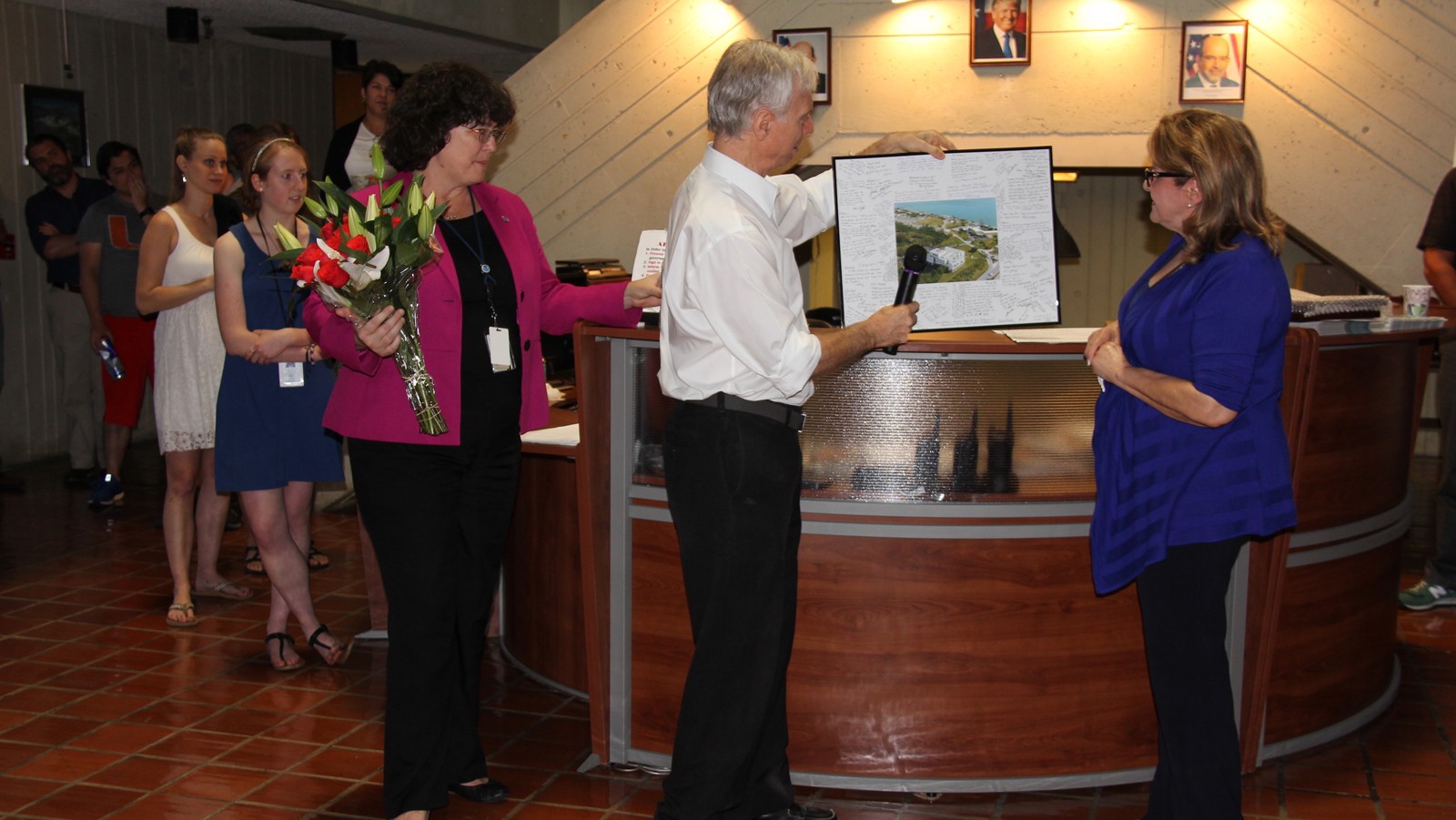 Dr. Atlas presents Gladys with a gift. Image credit: NOAA