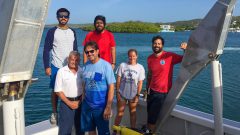 A group of scientists poses for a photo after a successful glider deployment. Photo Credit: NOAA AOML