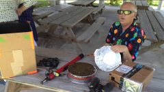 Hurricane scientist Neal Dorst sits with an array of solar eclipse viewing tools. Image credit: NOAA