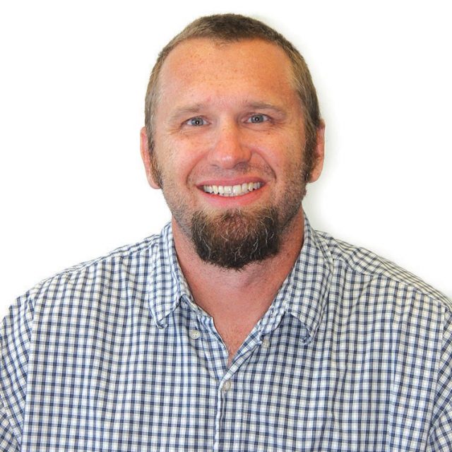 Color Portrait of Rik Wanninkhof in a blue check shirt with a white background