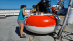 Two volunteers aboard the 2021 PNE cruise paint the base of a PIRATA buoy red.
