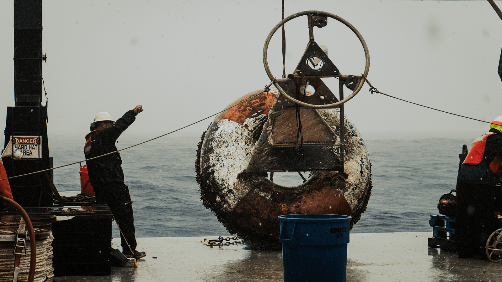 A very dirty PNE buoy is pulled aboard on the deck of the NOAA Ron Brown ship.