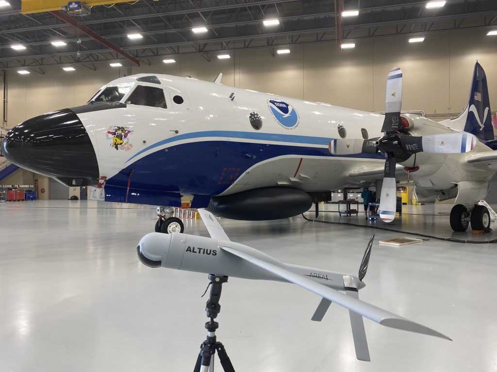 Altius demonstration model with NOAA WP-3D Orion Miss Piggy in the background.