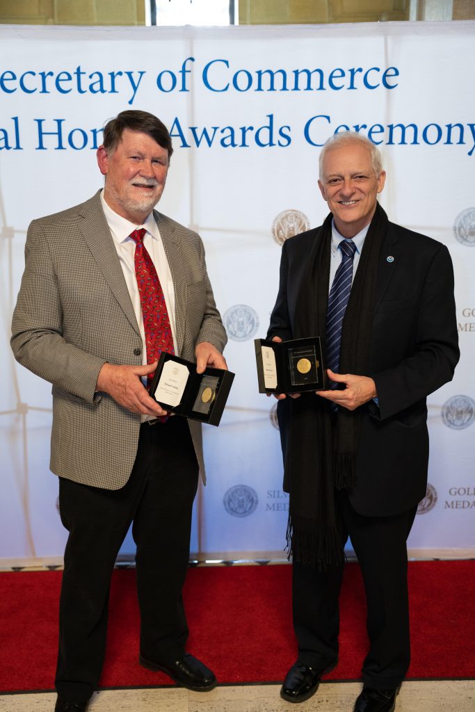 AOML scientist, Gustavo Goni (right), stands beside PMEL scientist, Ned Cokelet (left), after receiving the DOC Gold medal for saildrone.