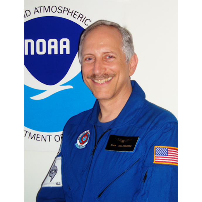 Headshot photo of Stanley (Stan) Goldenberg in his blue flight suit. Photo Credit: NOAA/AOML