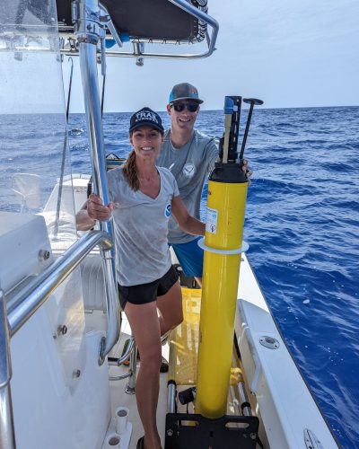 Scientists Jennifer McWhorter and Tim Holland stand aboard a research vessel after recovering a BGC Argo float off of Key West, FL.