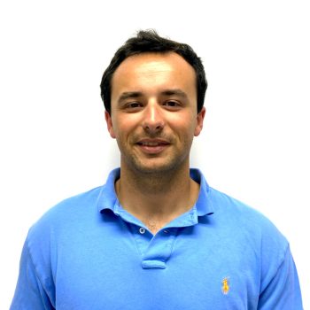 Color Portrait of Chris Malanuk wearing a blue polo shirt with a white background.