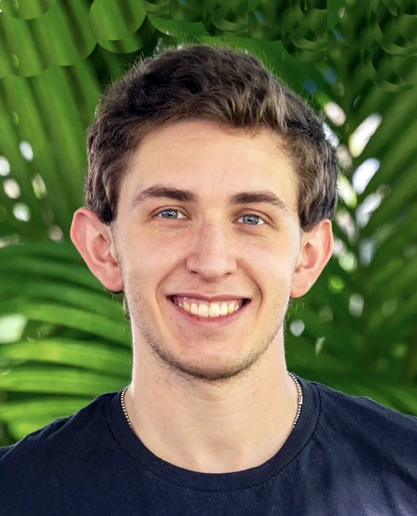 Color Portrait of Zachary Zagon with a green palm frond background