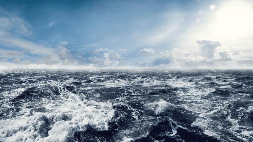 ocean surface with waves and blue sky