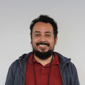 Fabian Gomez, Ph.D. smiles at the camera with a white background