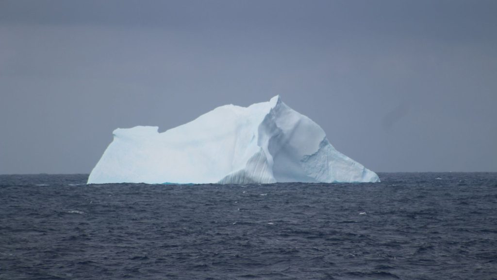A massive blue and white iceberg taes the photo in blue sea A13.5 GO-SHIP
